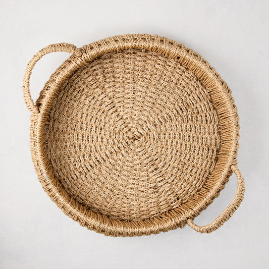 Small round woven abaca handled tray, natural brown, 16.5"Dia, with integrated handles and spiral weave.