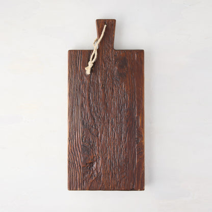 Dark brown European pine serving plank with handle and rope hanger.