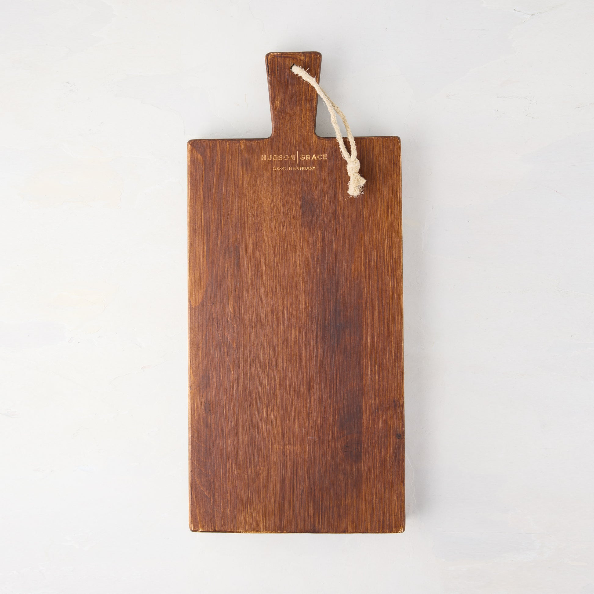 Small Saddle Wood Serving Plank, dark brown European pine, with a handle and rope hanger.