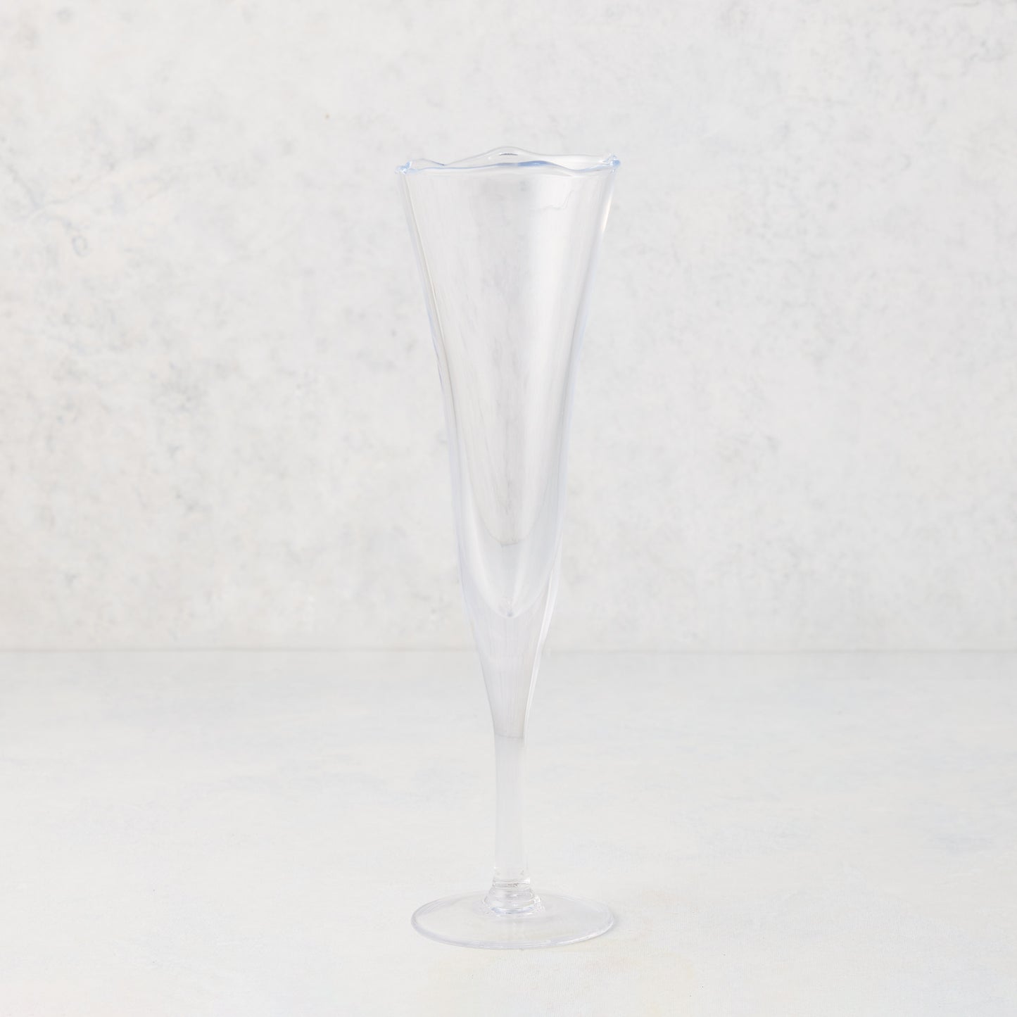 Clear, scissor-cut glass champagne flute with a rippled rim, 10 oz.