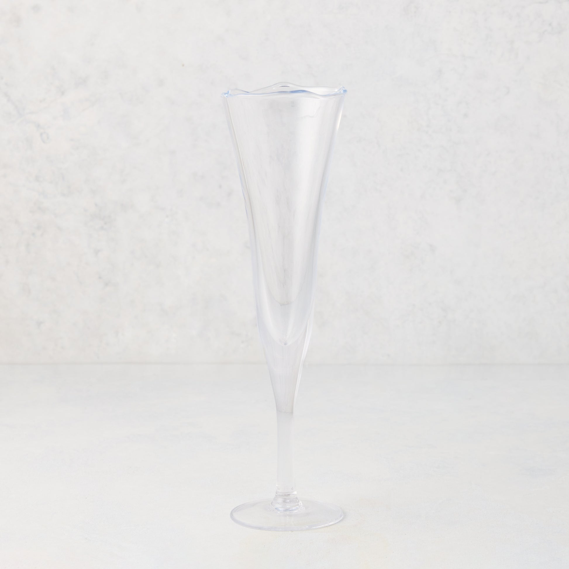 Clear, scissor-cut glass champagne flute with a rippled rim, 10 oz.