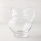 Clear, hand-blown Sutton Glass Pitcher with unique shape and handle.