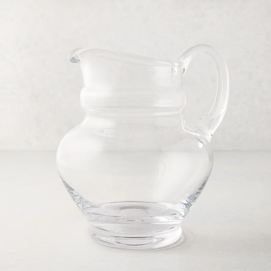 Clear, hand-blown Sutton Glass Pitcher with unique shape and handle.