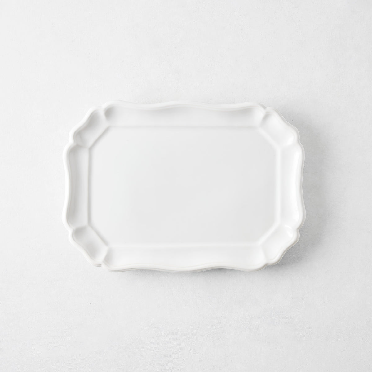 Small white ceramic Torcello serve platter with a scalloped edge, 11 by 8.4 inches, made in Italy.