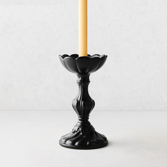 Small Tosca matte black ceramic candlestick with a yellow taper candle, vintage Italian design.