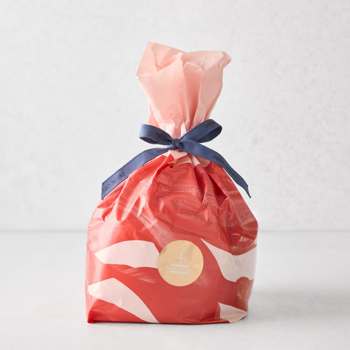 Hudson Grace Fiasconaro small panettone wrapped in red and white patterned paper with a blue ribbon tie