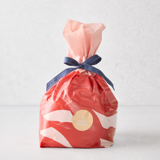 Hudson Grace Fiasconaro small panettone wrapped in red and white patterned paper with a blue ribbon tie