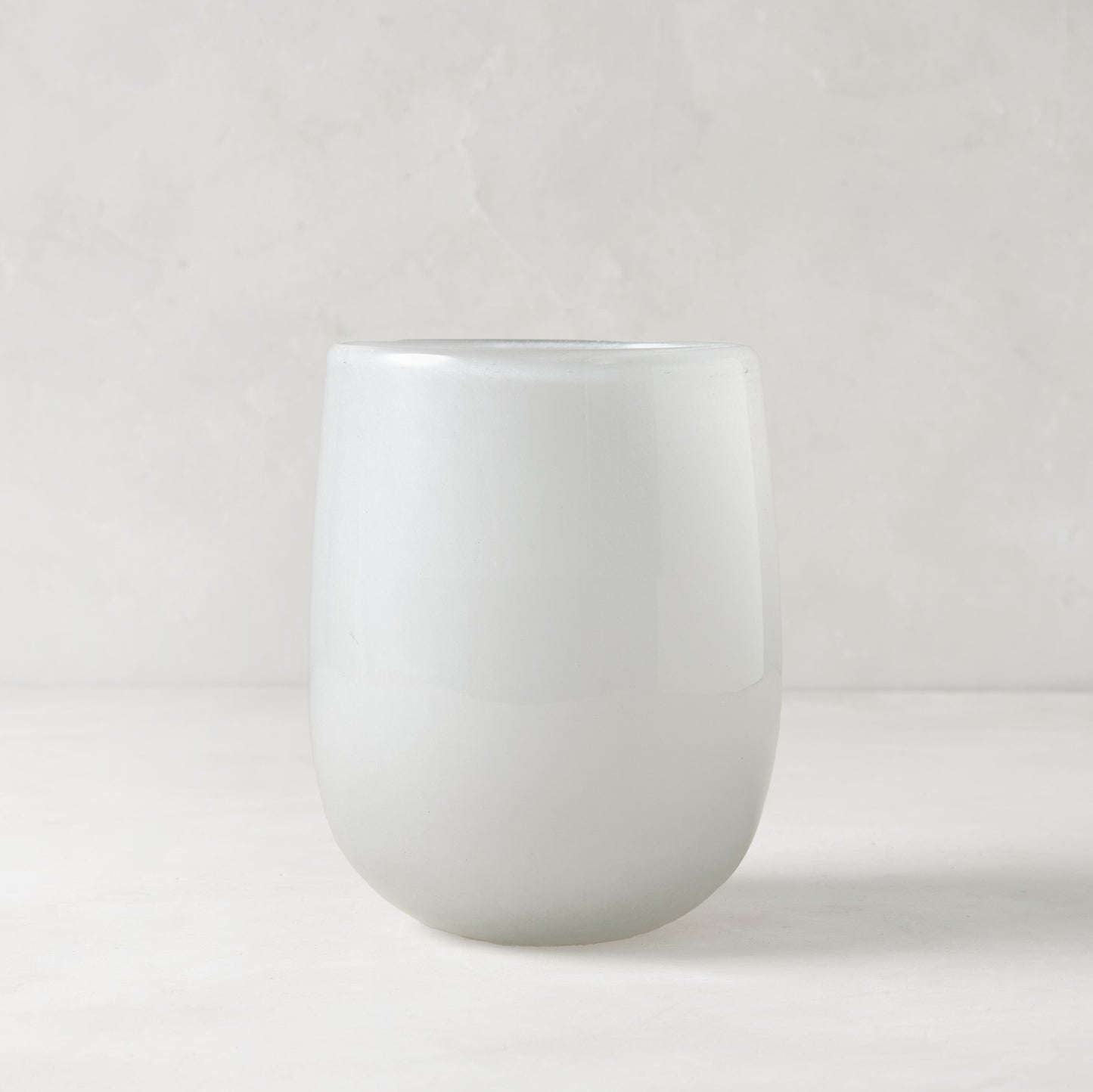 Small opaque white handblown glass barrel vase, 5.3"H x 3.9"W.