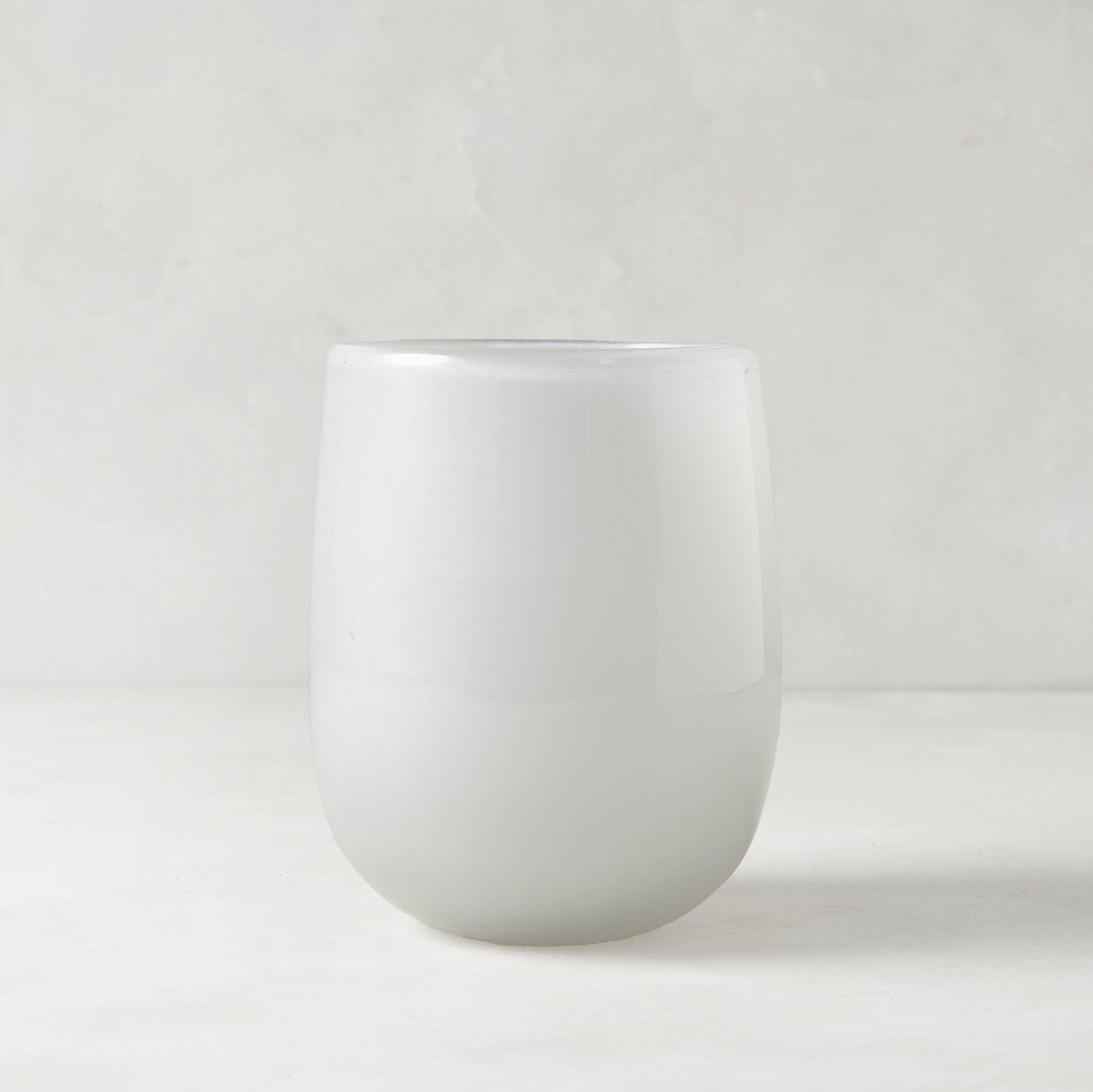 Small opaque white handblown glass barrel vase, 5.3"H x 3.9"W.