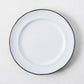 White enamelware salad plate with a dark rim.