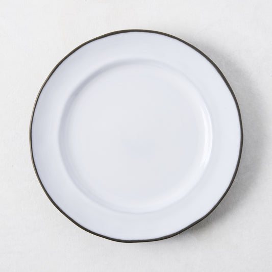 White enamelware salad plate with a dark rim.