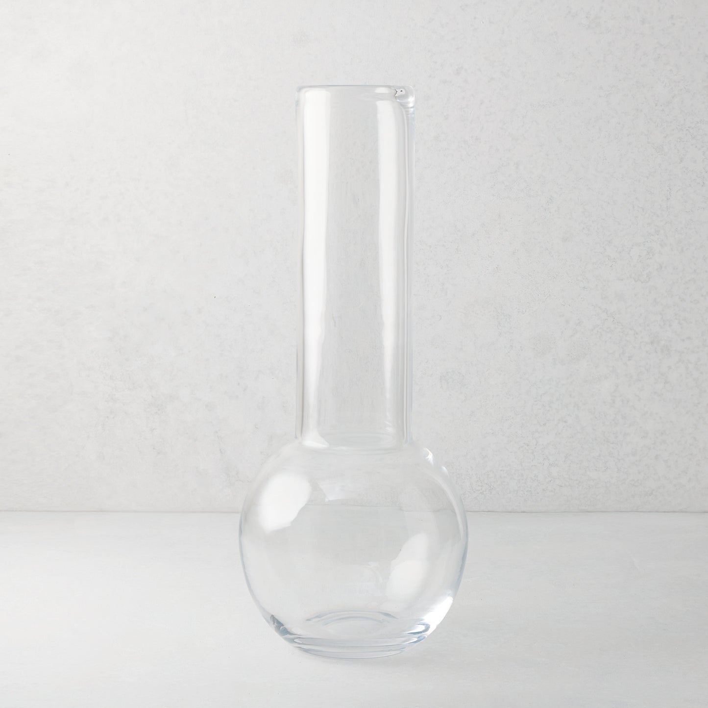 Sofia 17.5"H clear mouth-blown glass vase with a round base and tall, narrow neck.