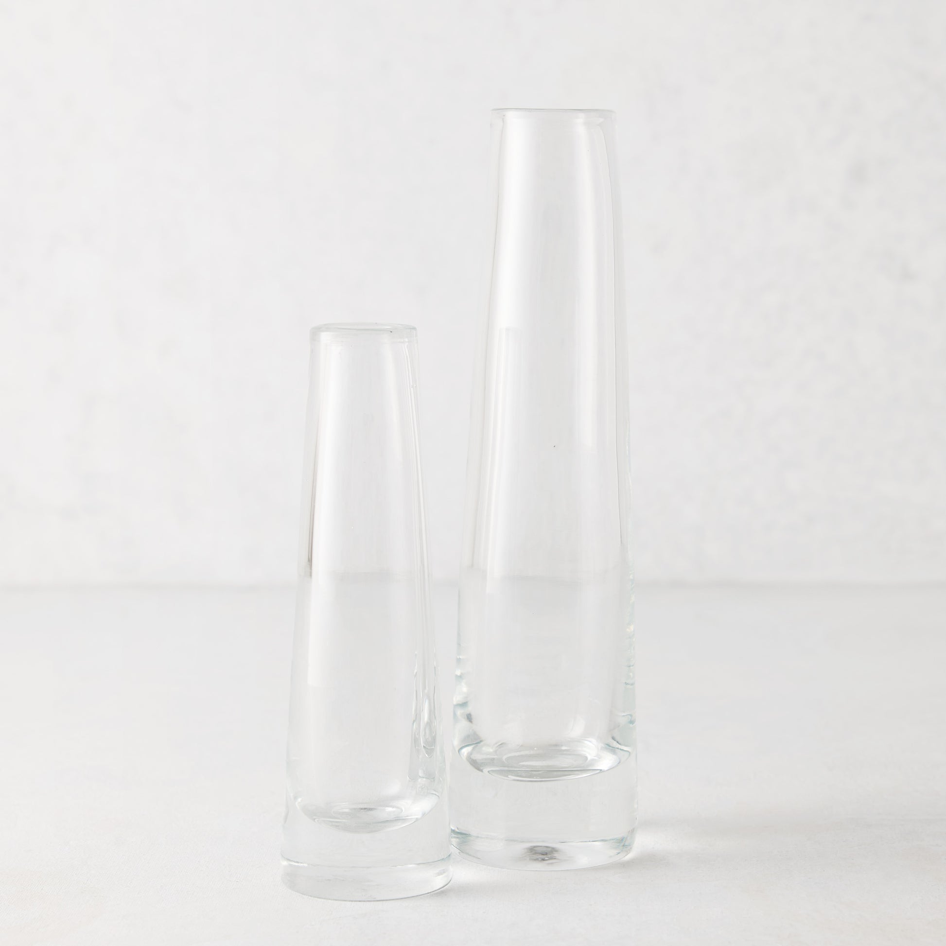 Two clear Solifleur mouth-blown glass bud vases, one large (8.27"H) and one small, on a white surface.