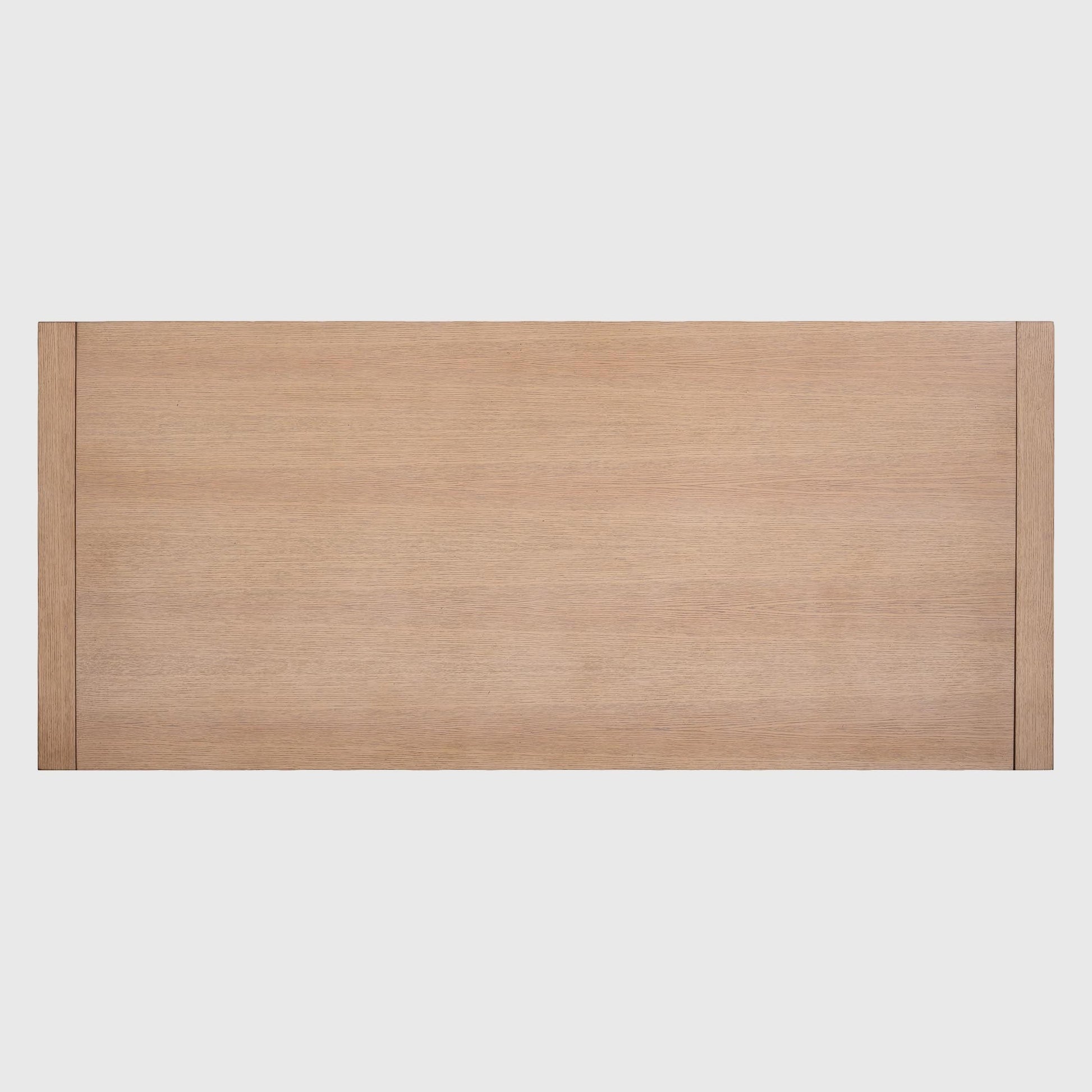 Solstice extendable oak dining table, top-down view, showing natural wood grain and sleek rectangular design.