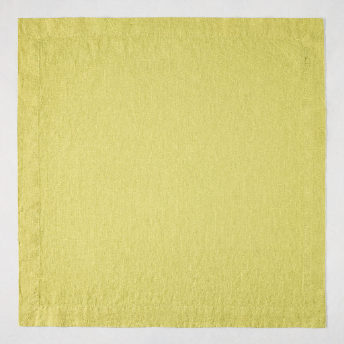 HG Sour Apple hand-dyed 22-inch square linen napkin with mitered corners.