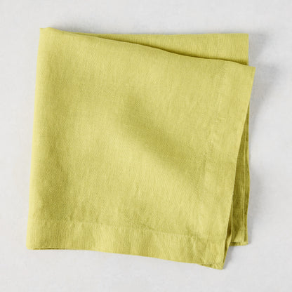 HG Sour Apple hand-dyed linen napkin, 22-inch square, folded on a light background.