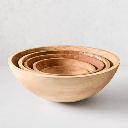 Set of five nested spalted maple wood bowls, light to medium brown with unique grain patterns.
