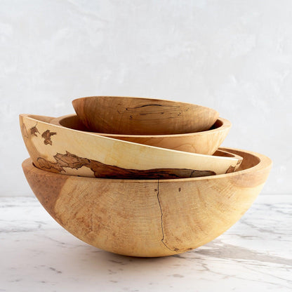 Stacked spalted maple wood bowls, natural light wood with unique dark grain patterns.