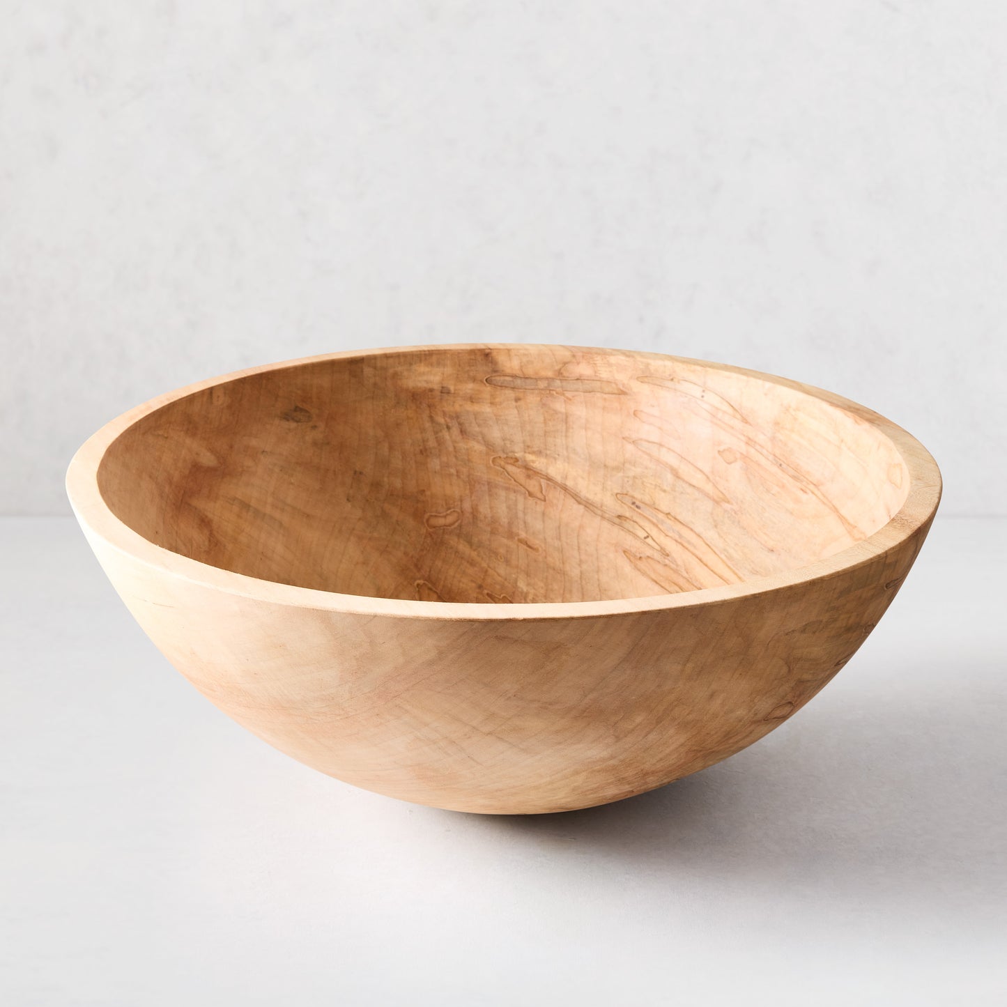 Large, light brown spalted maple wood bowl, 21 inches in diameter, with unique natural grain patterns.