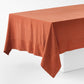 Spice-colored hand-dyed 100% linen tablecloth with 5-inch mitered corner detailing on a white table.