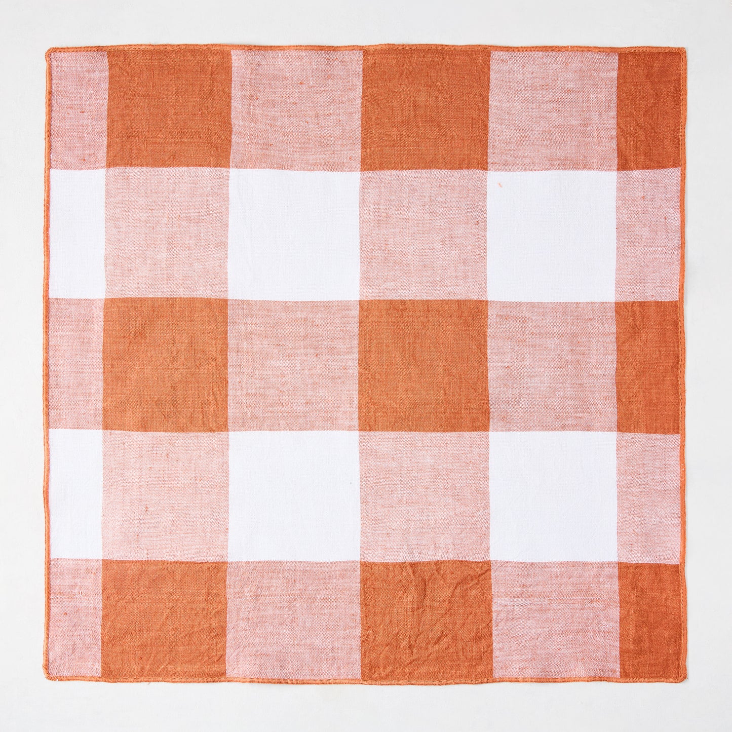 Spice orange and white buffalo check linen-cotton napkin, 20" square.