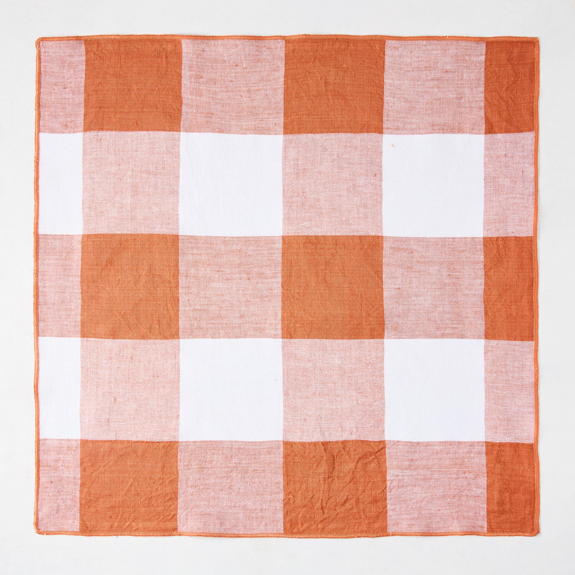 Spice orange and white buffalo check linen-cotton napkin, 20" square.