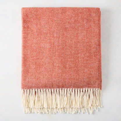 Spice Orange Italian Herringbone Throw Blanket, folded, with cream fringe.