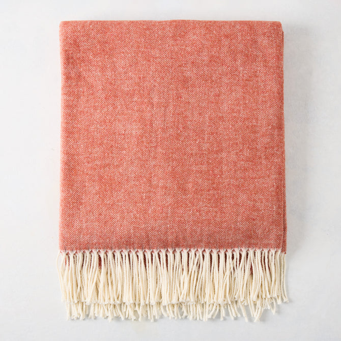Spice Orange Italian Herringbone Throw Blanket, folded, with cream fringe.