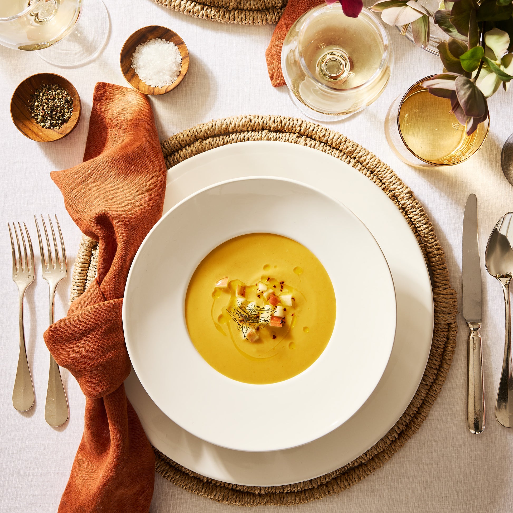 Spice HG hand-dyed linen napkin, 22", styled on a dining table with a white bowl of soup.