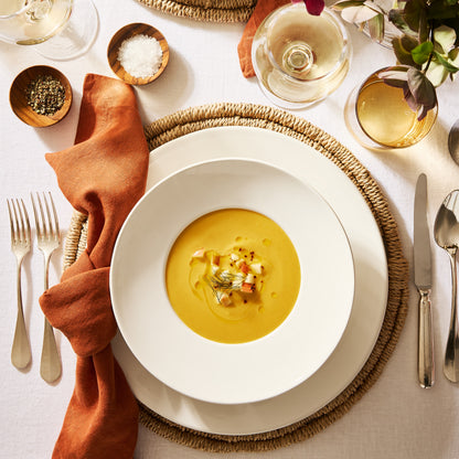 Spice HG hand-dyed linen napkin, 22", styled on a dining table with a white bowl of soup.