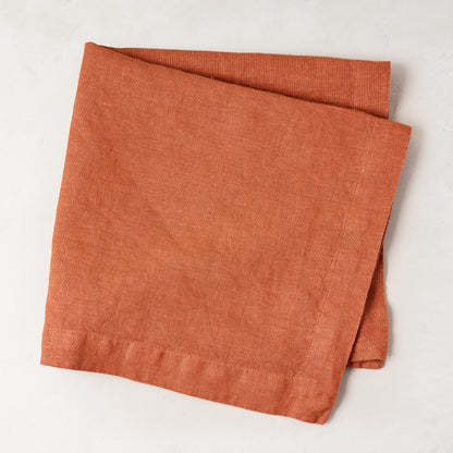 Spice HG Hand-Dyed Linen Napkin, 22" square, folded on a white surface.