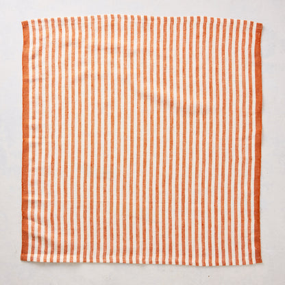 21-inch square linen napkin with orange and white ticking stripes and a solid orange border.