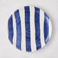 Handmade Italian ceramic salad plate with bold navy blue and white vertical stripes.