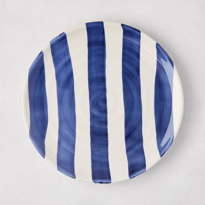 Handmade Italian ceramic salad plate with bold navy blue and white vertical stripes.