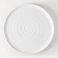 White ceramic Spiral Dinner Plate, 11.5" diameter, with subtle concentric rings.