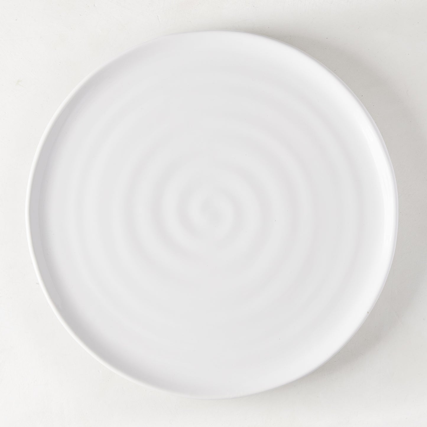 White ceramic Spiral Dinner Plate, 11.5" diameter, with subtle concentric rings.