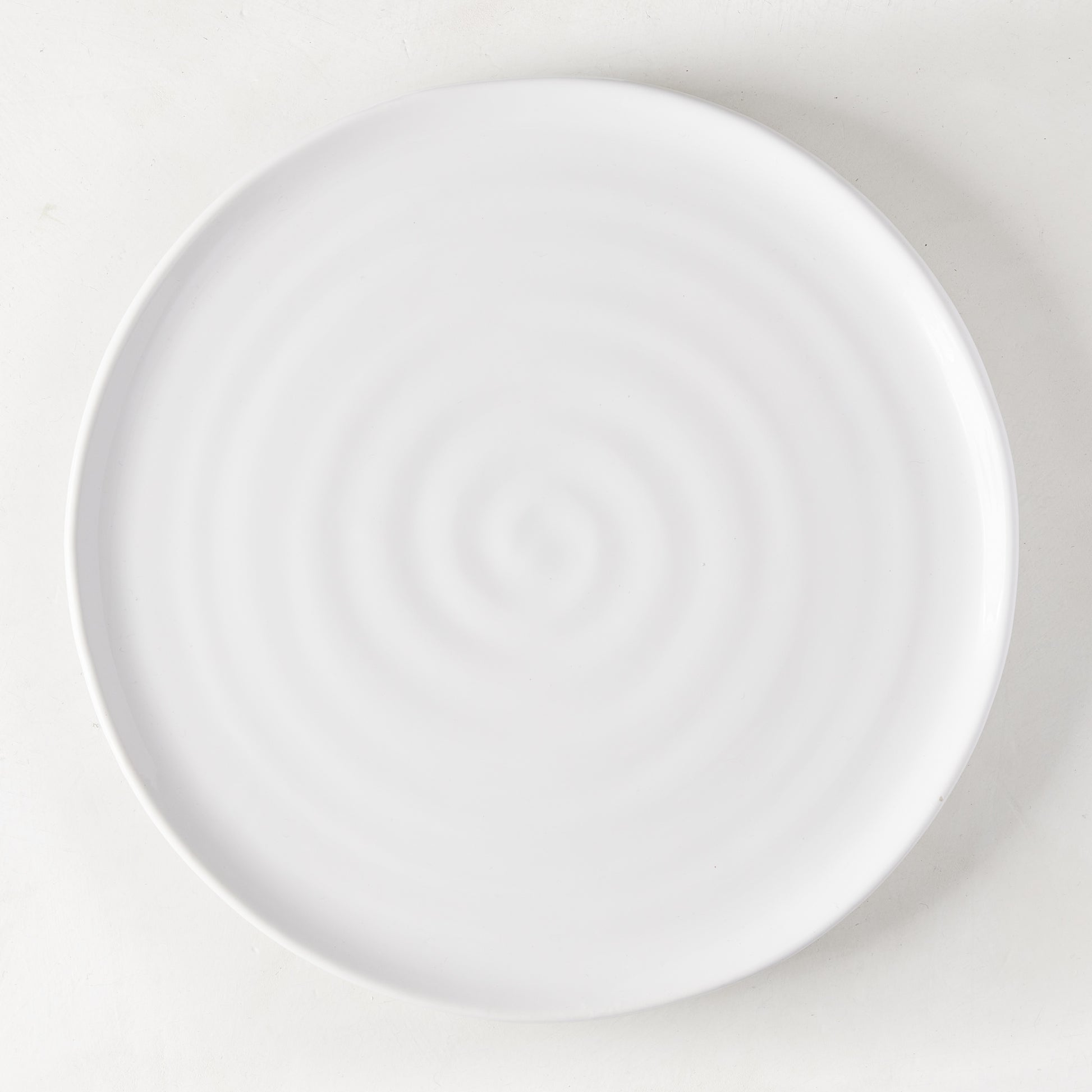 White ceramic Spiral Dinner Plate, 11.5" diameter, with subtle concentric rings.