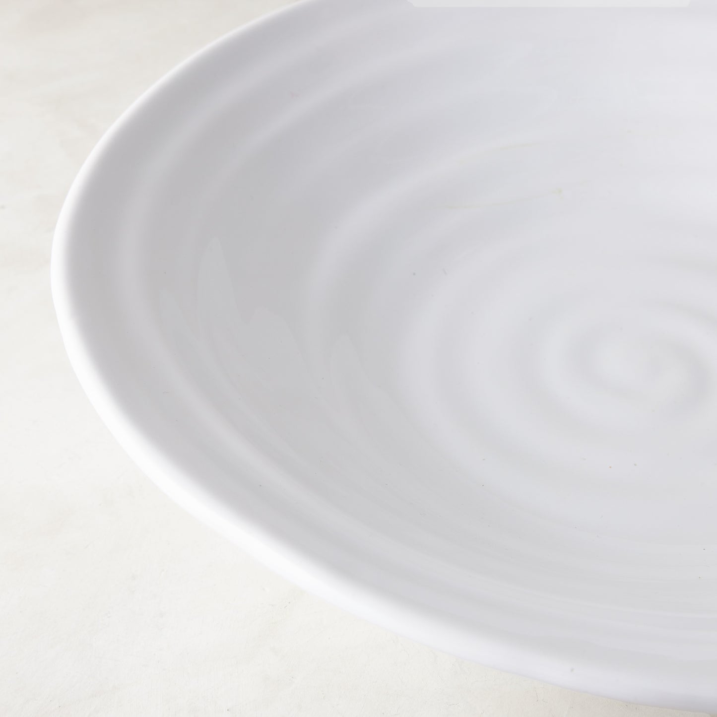 White ceramic Spiral Flared Serve Bowl, 15.5"Dia, with subtle concentric ridges.