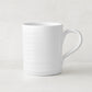 White ceramic Spiral Mug with subtle horizontal ridges and a curved handle.