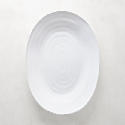 White ceramic oval serving platter with a subtle spiral design, 17"L x 12.5"W.