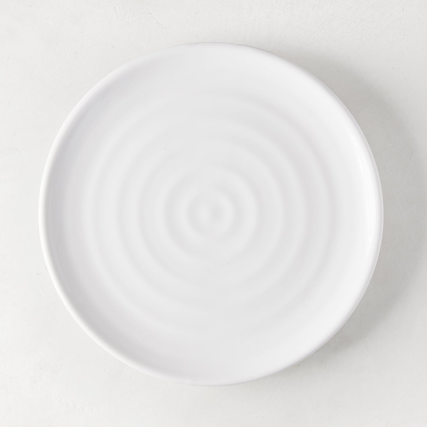 White ceramic spiral salad plate, 9" diameter, handmade in Italy.