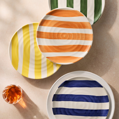 Handmade Italian ceramic salad plates with orange, yellow, blue, and green stripes, 9" diameter.