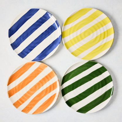 Four 9" ceramic salad plates with hand-painted diagonal stripes in blue, yellow, orange, and green.