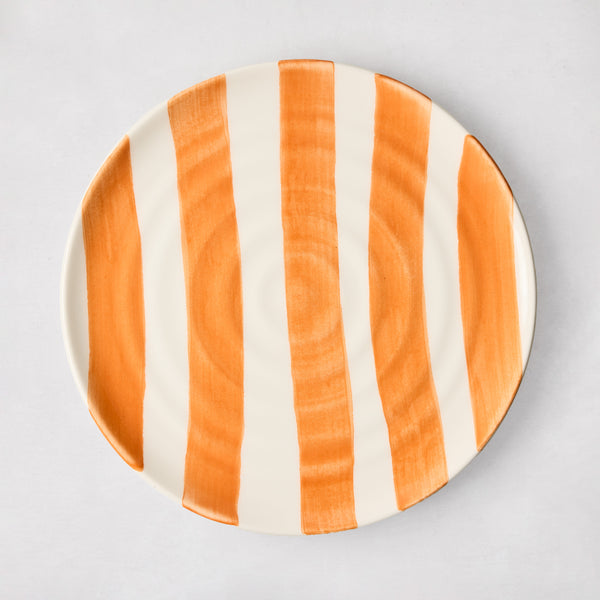 Handmade Italian ceramic salad plate with hand-painted orange vertical stripes and subtle spiral grooves.