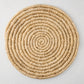 Round natural woven abaca placemat, 15" Dia, honey-brown hue, handcrafted, spiral design.
