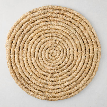 Round natural woven abaca placemat, 15" Dia, honey-brown hue, handcrafted, spiral design.