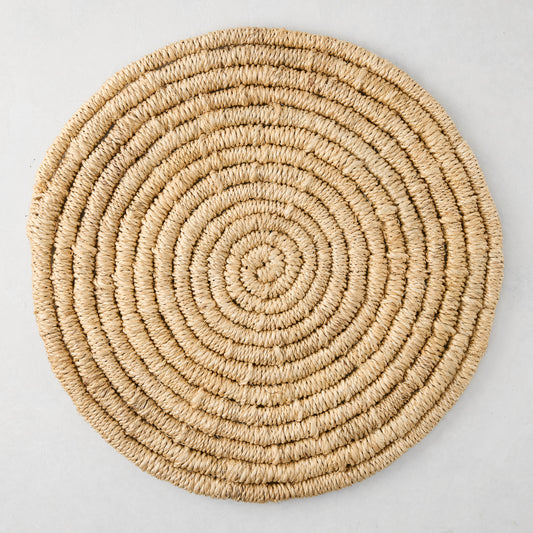 Round natural woven abaca placemat, 15" Dia, honey-brown hue, handcrafted, spiral design.