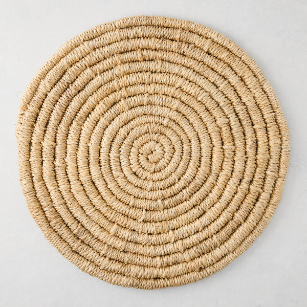 Round natural woven abaca placemat, 15" Dia, honey-brown hue, handcrafted, spiral design.