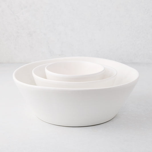 Set of 3 white ceramic spiral stacking serve bowls, small, medium, and large.
