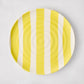 Handmade Italian ceramic salad plate with yellow vertical stripes and subtle spiral grooves.